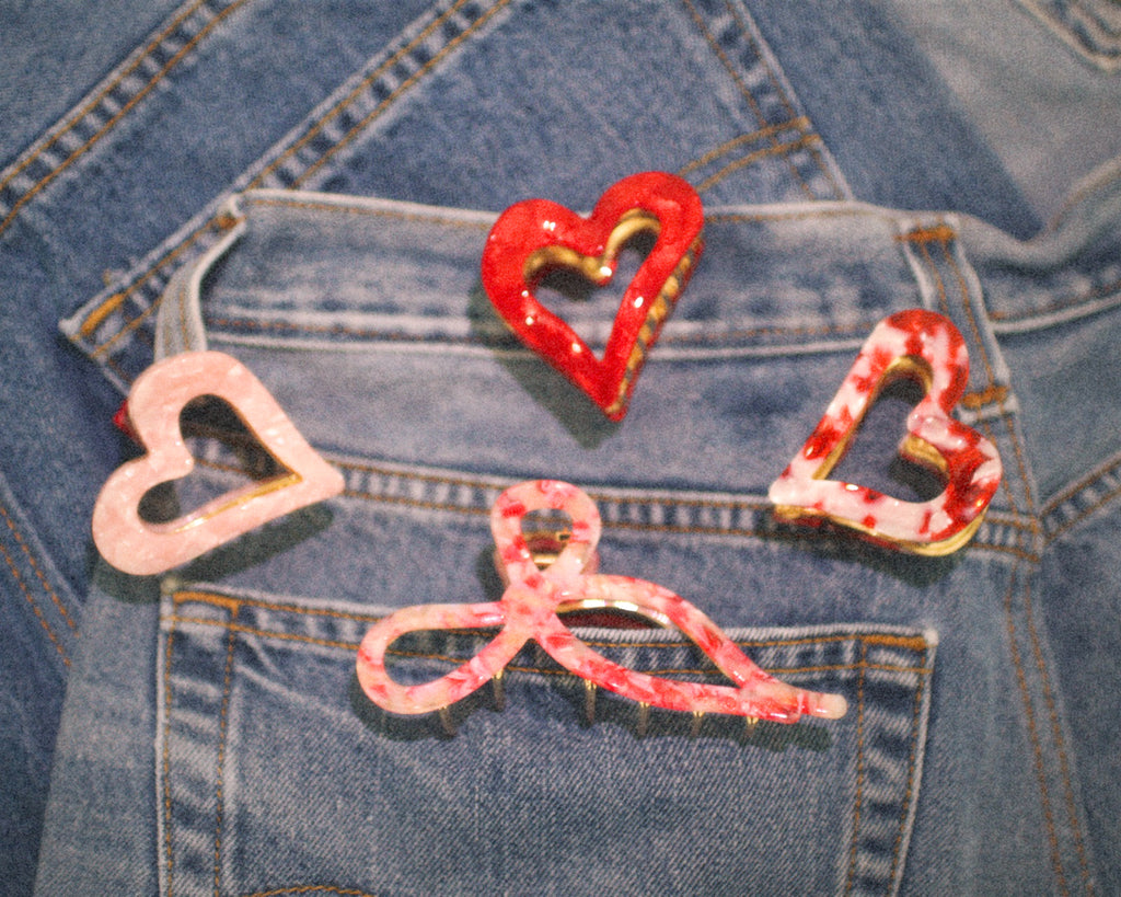 Heart-shaped and bow-shaped buttons on a denim fabric background
